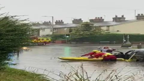 Sally Roberts A woman and her pug dog being rescued