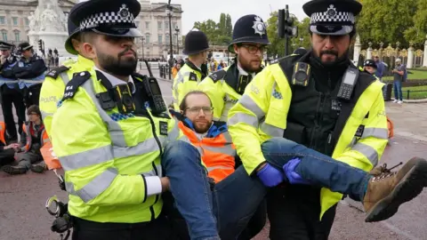 PA Media Protestors being removed by police