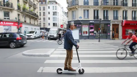 Getty Images A man rides an electric scooter in Paris on 17 June 2019