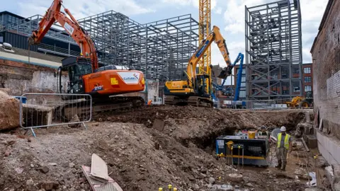 Getty Images Two diggers work on demolition of old industrial and factory buildings to make way for housing in Birmingham