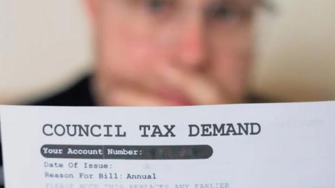 Man looking at a council tax bill