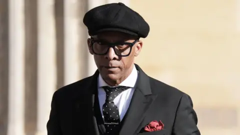PA Media Jay Blades in a black cap and black jacket