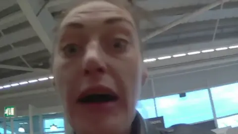 COPFS A woman with brown hair and a leather jacket in a still from a body cam