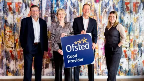 BCP Council Two men and two women stand in front of a sign that says "Ofsted good provider" - the men are wearing suits with no ties. The women are wearing smart trousers.