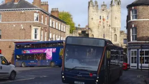 Buses on Blossom Street with Micklegate Bar in the background