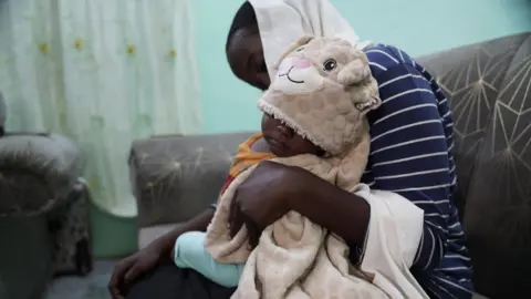 Unicef Hala (not her real name) holds her baby.