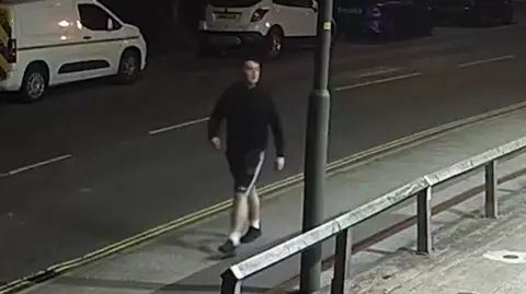 An image of Paul Jinks walking through a street in Long Eaton whilst stalking a woman