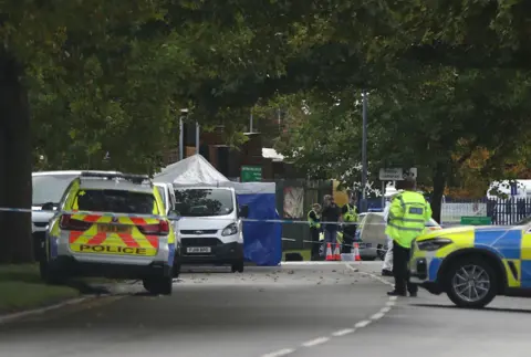 PA Media A police cordon in Ascot Drive, Derby