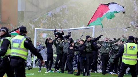 PA Media Celtic fans invade the pitch following their team penalty shoot out win after the Scottish Gas Men's Scottish Cup quarter-final match at Ibrox Stadium, Glasgow