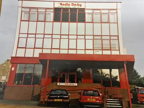 A red and white building with BBC RADIO DERBY on the side