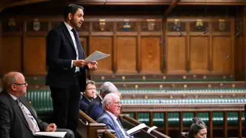 Reuters Lester South MP Shockat Adam speaks from the backbench to the House of Commons during a debate earlier this year