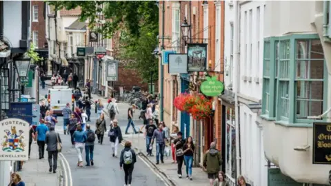 Getty Images High Petergate - taken from above - the street is busy with tourists and was taken in spring or summer as many are in short sleeves.