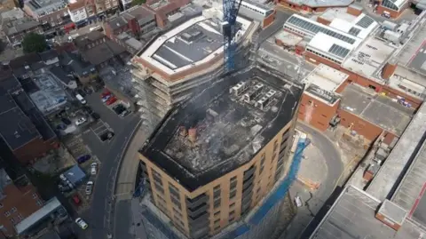 SURREY FIRE AND RESCUE SERVICE Birds eye view of the damaged block of flats from the fire 