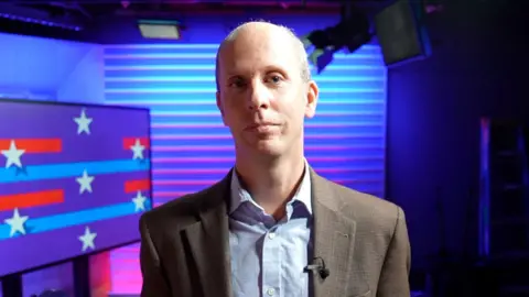 Anthony Zurcher standing in a TV studio