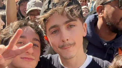 @fizzysodatoes Timothée Chalamet (C) poses with lookalike at contest in New York