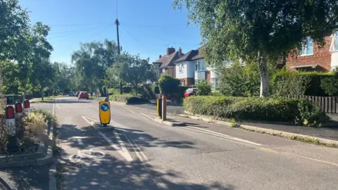 A general view of Windsor Road, which has cycle lanes on both side of a single-vehicle traffic-calming measure.