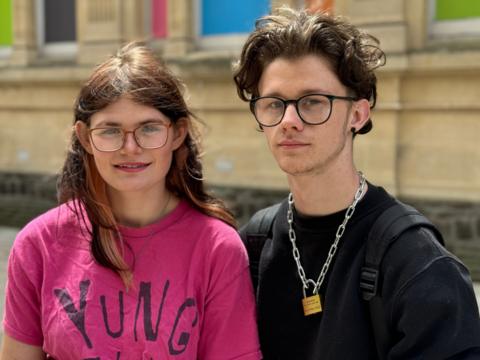 Two young people standing together in Cardiff town centre in front of the old library