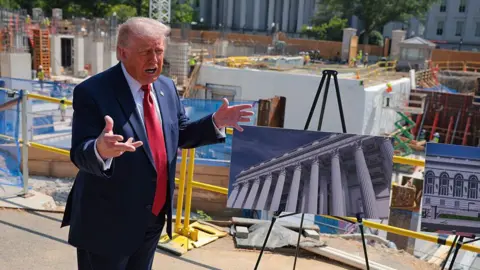 President Trump showing a rendering of the ballroom in front of construction materials on 19 May. 