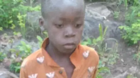 Mutsa Murombedzi/Twitter The young boy wearing an orange shirt after being found 