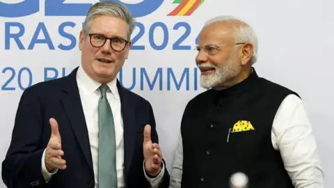 UK Prime Minister Sir Keir Starmer (left) and Indian Prime Minister Narendra Modi (right) talking at the 2024 G20 summit in Brazil