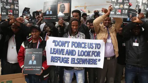 Getty Images African asylum seekers, mostly from Eritrea, who entered Israel illegally during the past years, hold placards showing migrants who they say were killed after being deported to their country, during a protest against Israel's deportation policy in front of the Supreme Court in Jerusalem on January 26, 2017.