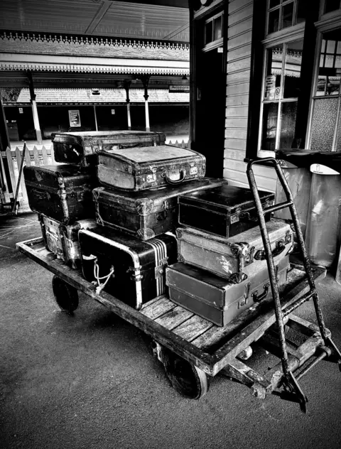 Colin Whitton A luggage trolley is piled high with cases