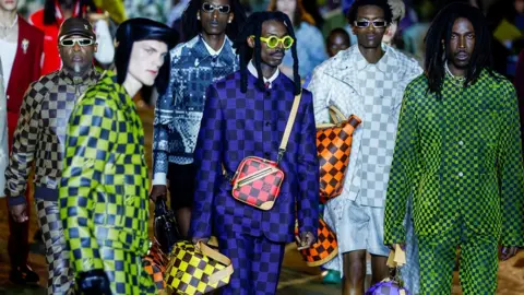 Reuters Louis Vuitton's familiar check patterns and leather work featured heavily on the runway, as well as military-style camouflage