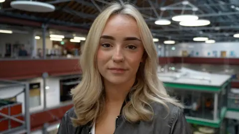 BBC News Hannah, a sixth-form student, looks into the camera. She has agelong  blonde hairsbreadth  and is wearing a acheronian  grey jacket.