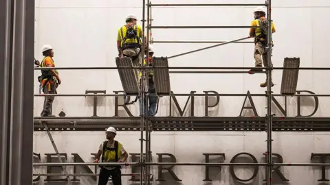 Getty Images Workers put up scaffolding prior to the removal of President Donald Trump's name from the Kennedy Center on June 12, 2026 in Washington, DC.