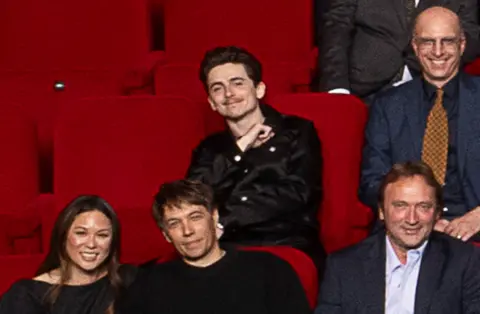 AMPAS Timothée Chalamet, Samantha Quan and Sean Baker in the 97th Oscars nominees dinner class photo