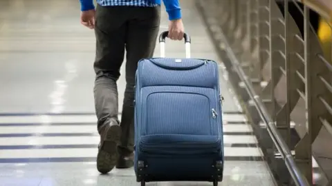 Getty Images Man with a suitcase