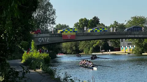 Zoe Broughton Rowing crews pass under the River Thames 