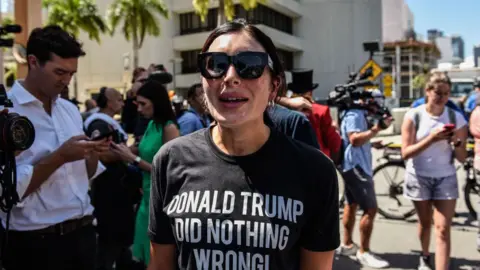 Getty Images Laura Loomer wearing a Trump T-shirt in Florida in 2023