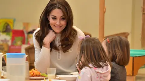Getty Images The Princess of Wales talks to two children on a visit to a nursery in January 2020
