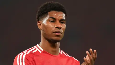 Manchester United forward Marcus Rashford claps fans