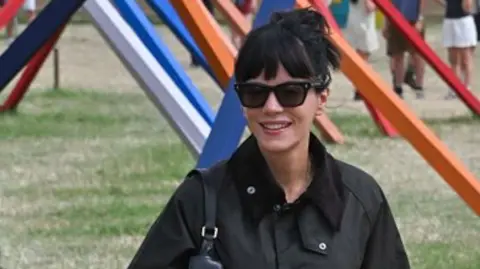 Lily Allen wearing black and in sunglasses, on day two of Glastonbury Festival 2025
