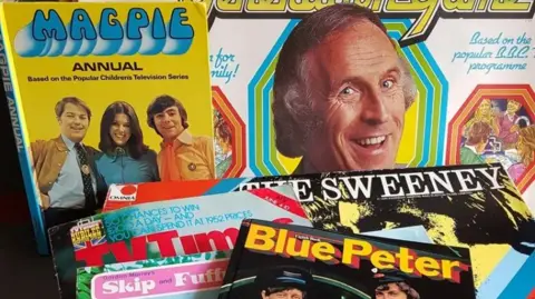 A collection of magazines from the 190's featuring Bruce Forsyth, a Magpie annual (based on the popular children's television series), The Sweeney, Blue Peter and a copy of the TV Times.