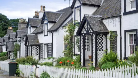 Getty Images Row of white houses in the village Kenmore, Perth and Kinross, Perthshire in the Highlands of Scotland