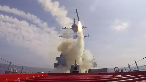 A missile launches from a warship during Operation Epic Fury.
