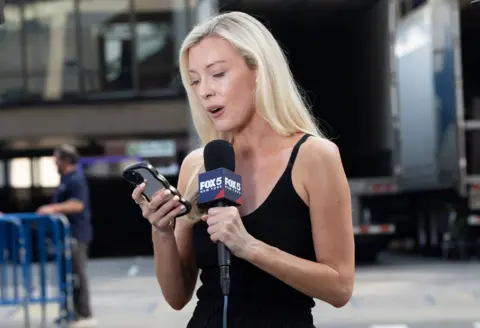Getty Images Fox 5 News reporter is seen near Madison Square Garden on July 1, 2026 in New York, New York, ahead of the rumoured wedding of Taylor Swift and Travis Kelce.