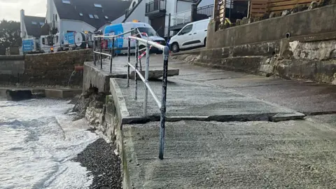 Isle of Wight Council A section of slipway has a large crack across its entire width. An apparently dislodged block of concrete can also be seen higher up the slipway.