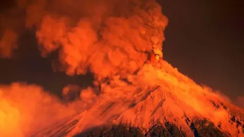 EPA A view of the Fuego volcano eruption at sunrise, seen from El Rodeo, Escuintla, Guatemala, 19 November 2018.