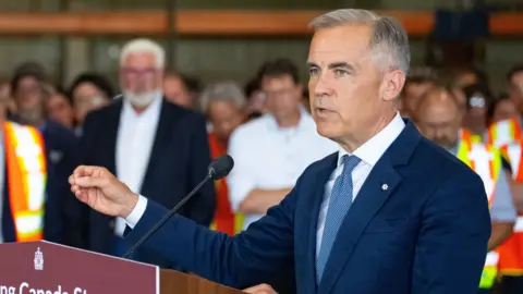 Mark Carney speaking to reporters in Hamilton