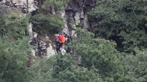 Devon Cave Rescue Organisatio Rescuer on cliff