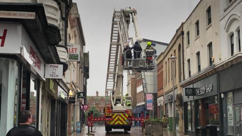 The emergency services in Ipswich town centre after a man was reported on the roof of a building