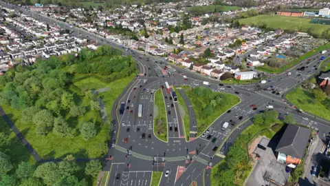 An aerial visualisation of Dawsons Corner when the works are completed. The road features numerous lanes with traffic heading towards Bradford in one direction and Leeds in the other.