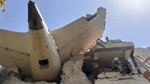 Central Industrial Security Force/India An image from below of the plane lodged in the side of a building in Ahmedabad