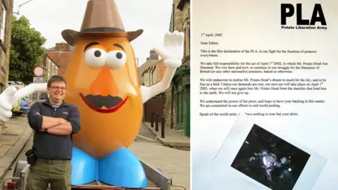 Adrian Farmer Two images. Left a man stood next to a giant Mr Potato Head statue on the back of a trailer. Right, a typed letter with a polaroid of a giant Mr Potato Head wrapped in tin foil.