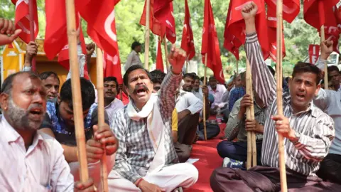 EPA Indian members of the Federation of the Trade Unions Delhi committee shout slogans and attend a rally to mark International Labour Day in Delhi, India 01 May 2018.