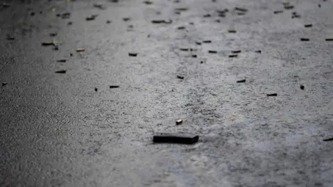 Getty Images Bullet caskets are seen on the ground at the crime scene after Mexico City's Public Security Secretary Omar Garcia Harfuch was wounded in an attacked in Mexico City, on June 26, 2020